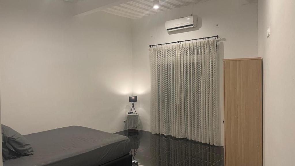 Postel nebo postele na pokoji v ubytování Nukumari villa & Homestay