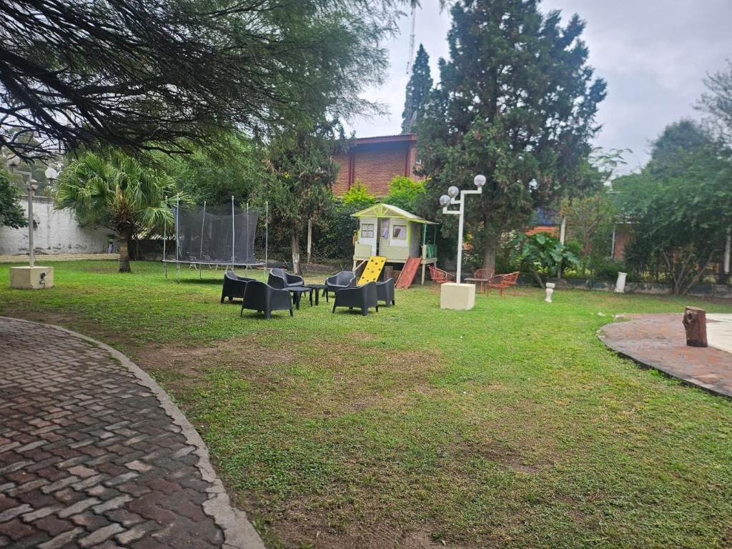 a park with a group of chairs in the grass at Finca Don Celestino in La Banda