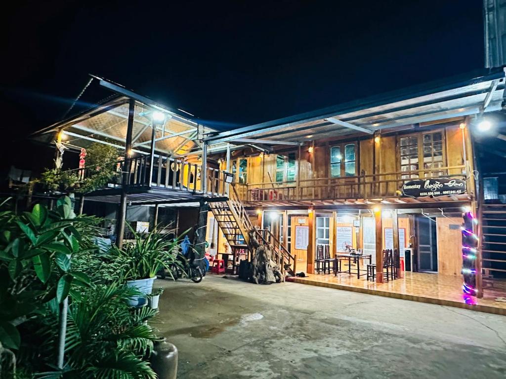 a building with a staircase in front of it at night at Homestay Quyền Đen in Mù Cang Chải