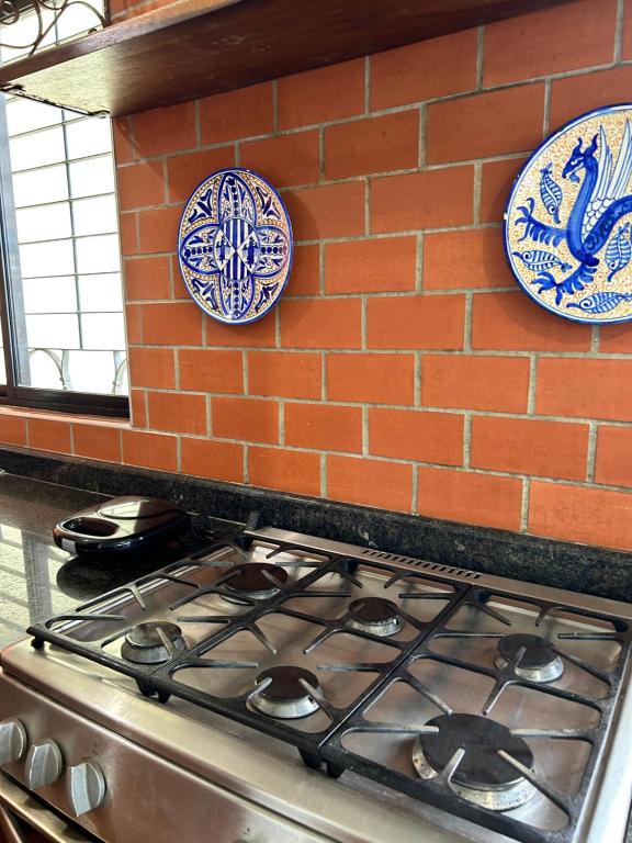 a stove top with plates on a brick wall at Comfort and a perfect location in Valencia
