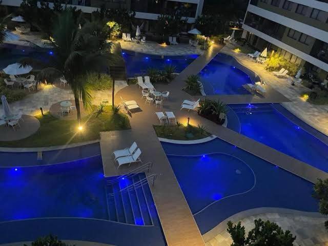an aerial view of a swimming pool at night at Malawi Resort Essence in Porto De Galinhas