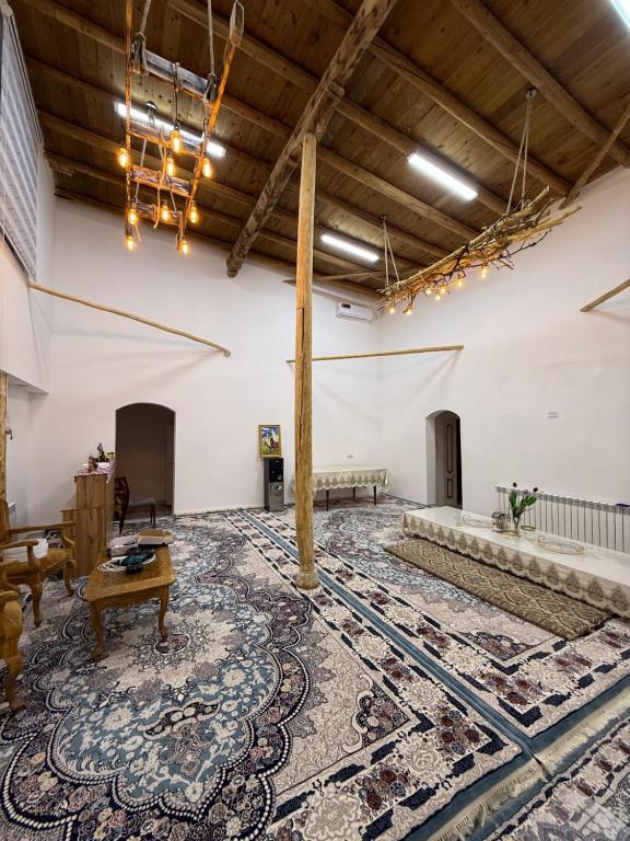 a large room with a rug on the floor at Sarzamin Guest House in Khiva