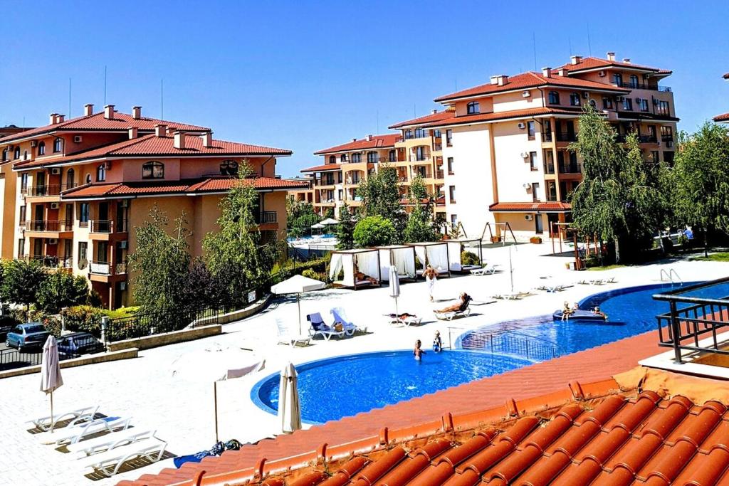 a large swimming pool in a resort with buildings at Family Apartment Near Beach, Pools & Star dreams Complex in Sveti Vlas