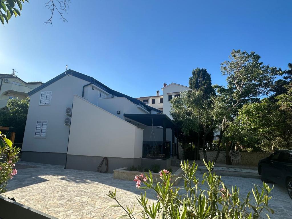 a white building with a large white wall at Villa EnVi in Novalja