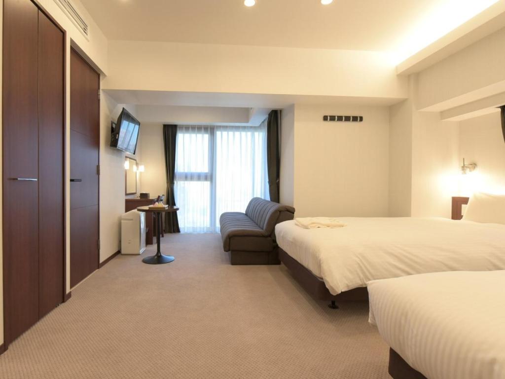 Postel nebo postele na pokoji v ubytování HOTEL BRILLIO ASAKUSABASHI