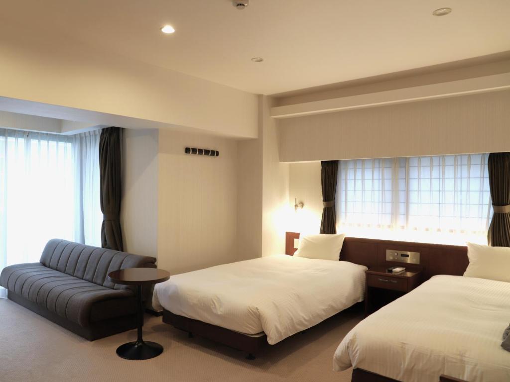 Postel nebo postele na pokoji v ubytování HOTEL BRILLIO ASAKUSABASHI