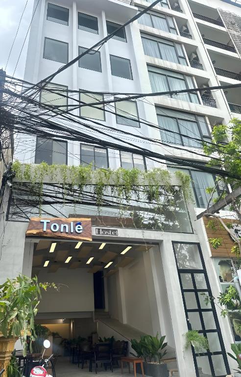 a building with a sign on the front of it at Tonle Hostel in Phnom Penh