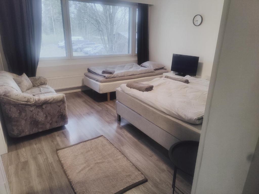 Ένα ή περισσότερα κρεβάτια σε δωμάτιο στο Helmiapartments Sotkamo