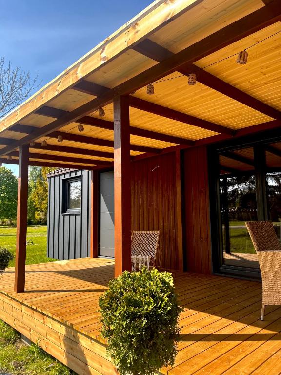 drewniany taras z 2 krzesłami w obiekcie Holiday Resort Zakątek Łeba w Łebie