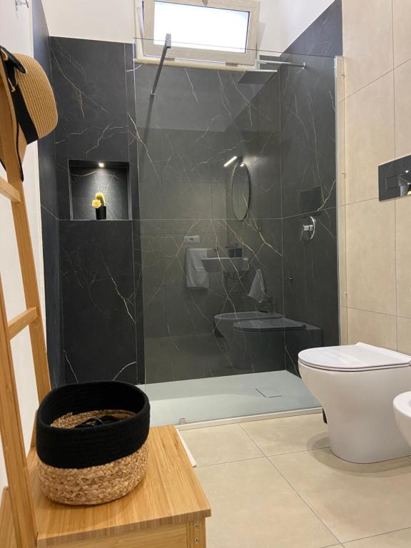 a bathroom with a shower with a toilet and a sink at La Stella dei Venti in Porto Empedocle
