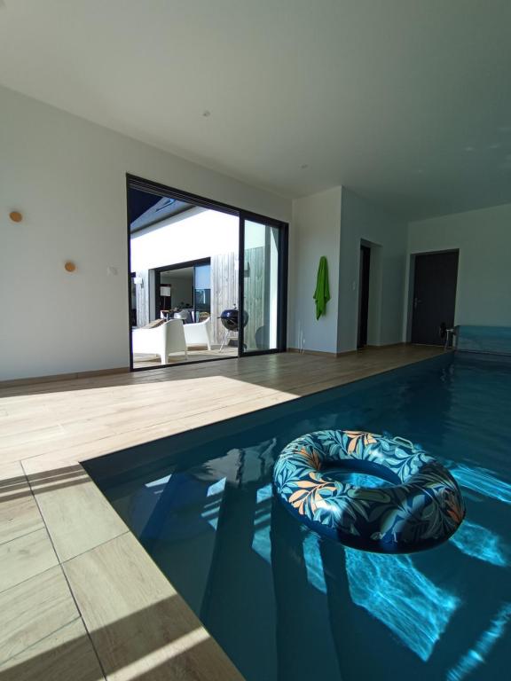 ein Swimmingpool mit einem Sitzsack im Wasser in der Unterkunft Jolie Maison avec piscine intérieure à 5 minutes des plages in Landunvez