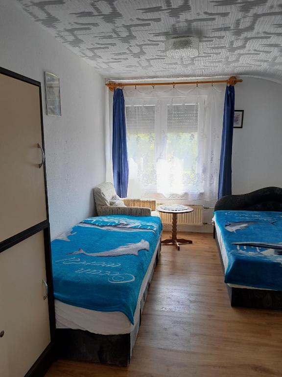Posteľ alebo postele v izbe v ubytovaní György Vendégház