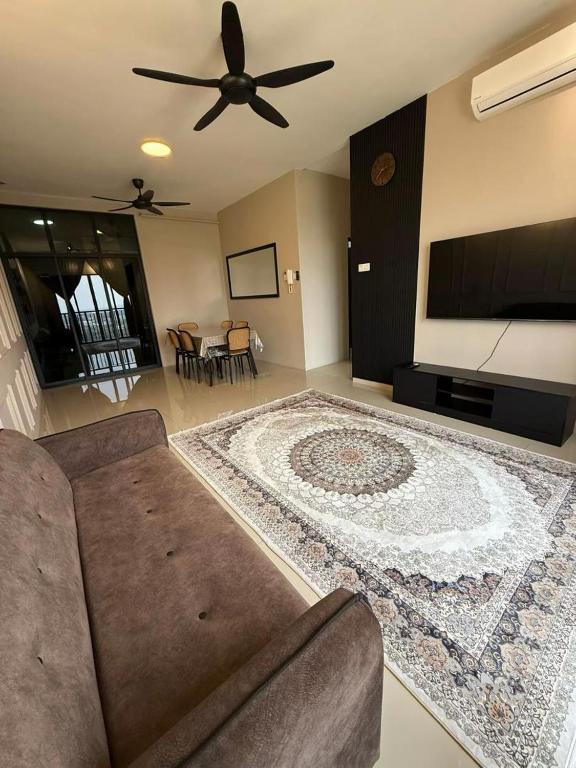 a living room with a couch and a flat screen tv at Alisha Homestay at Residensi KLIA near KLIA AIRPORT,SEPANG CIRCUIT,USIM,BANDAR ENSTEK in Nilai