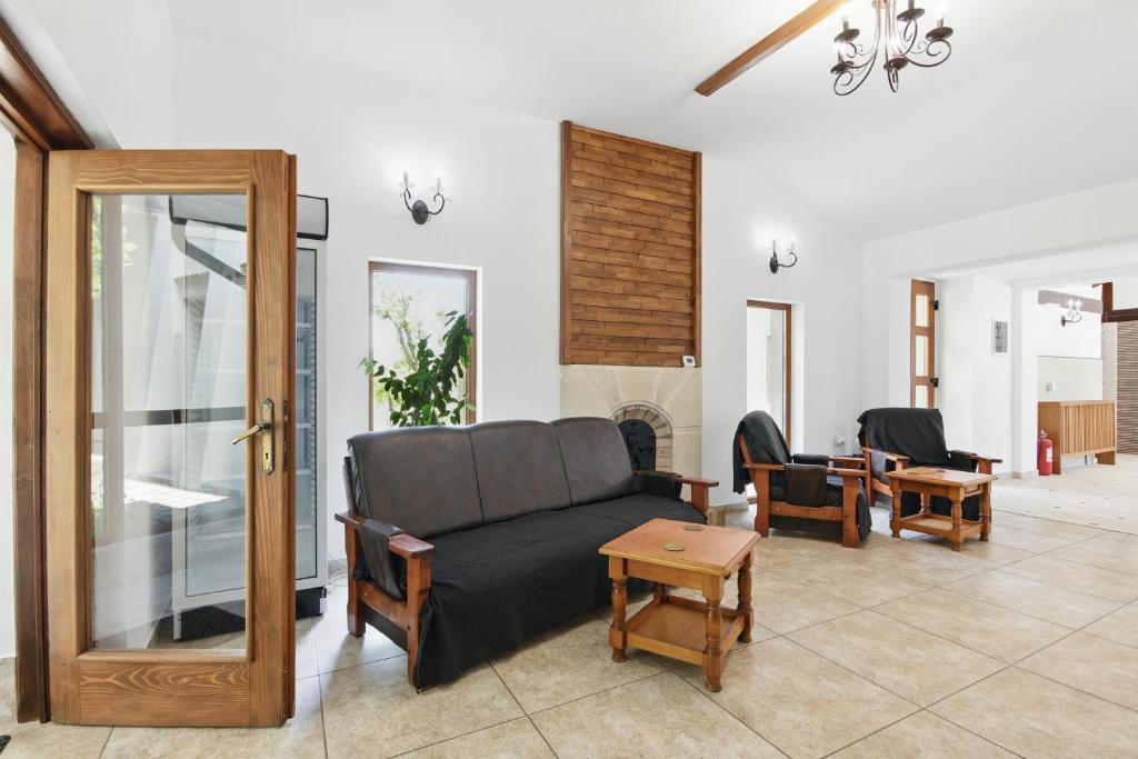 a living room with a couch and a table at Casa Galand in Pîrscov