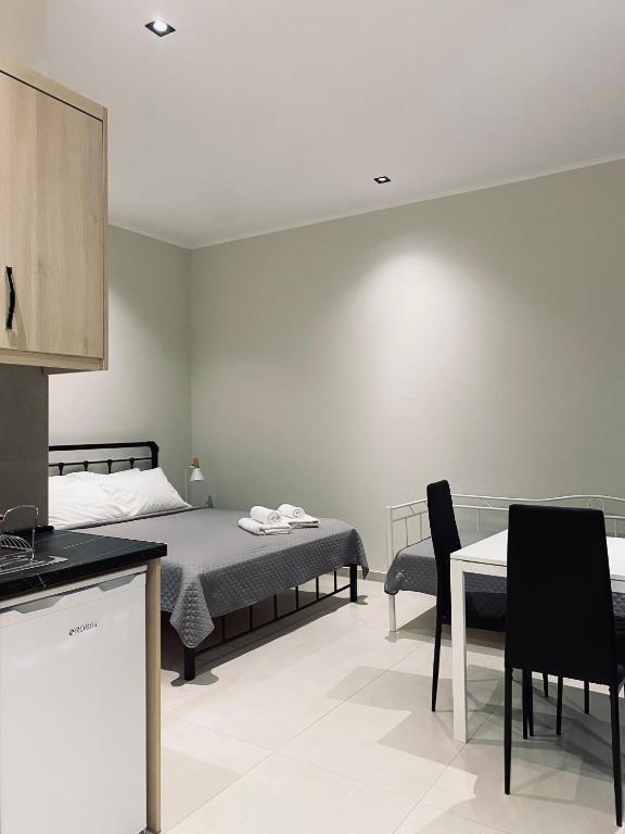 a bedroom with a bed and a table and chairs at Catherine's Studios Sivota in Syvota