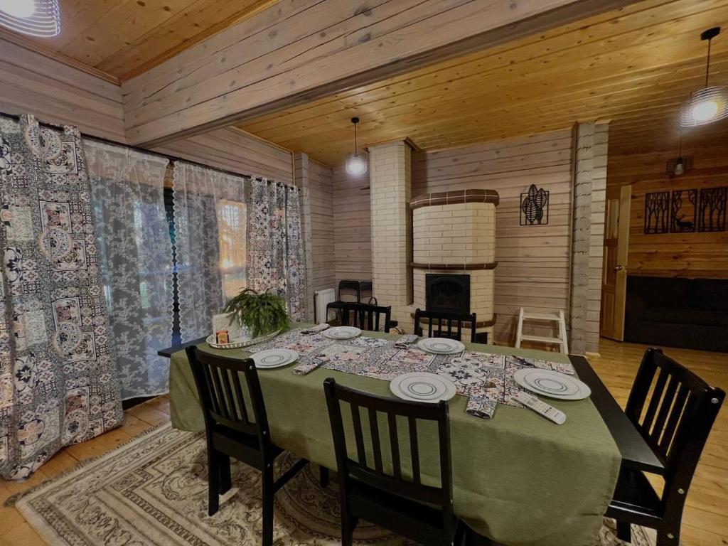 a dining room with a table and chairs in a room at Serri Villa in Vardenis