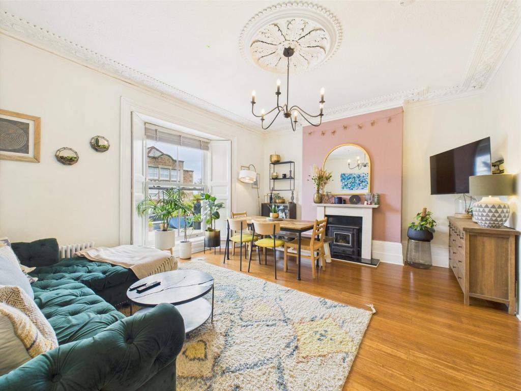 a living room with a couch and a table at Beautiful Georgian Apartment | Near Falmouth Town Centre | Walk to Shops, Pubs & Restaurants in Falmouth