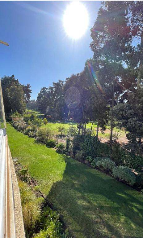 a view of a garden with a rainbow at Lindo departamento vista Club de golf Santo domingo, cerca de parque Tricao in Santo Domingo