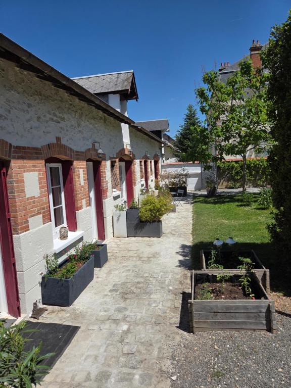 une cour d'un bâtiment avec des plantes en pot dans l'établissement La Renardière, à Bourges