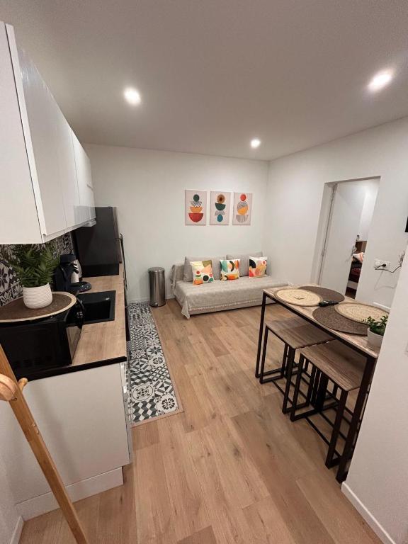 une cuisine et un salon avec une table et un canapé dans l'établissement Évasion cosy, proche de Paris, à Argenteuil