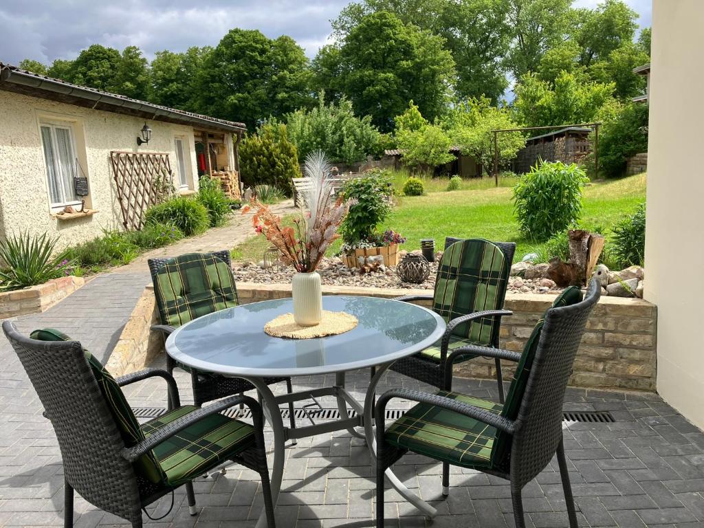 a patio with a blue table and chairs at Ferienwohnung Seestraße in Plau am See