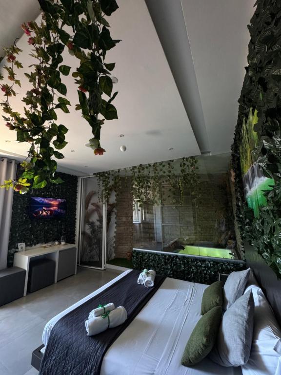 a bedroom with a large bed with plants on the wall at La collina di Capodimonte in Naples