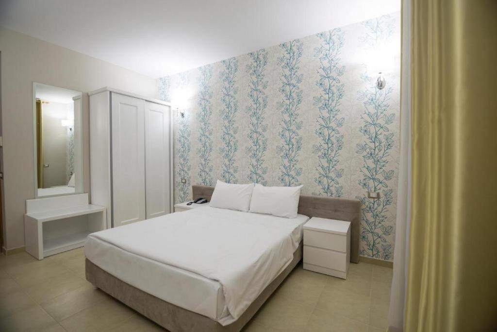 Postel nebo postele na pokoji v ubytování Sun Hotel
