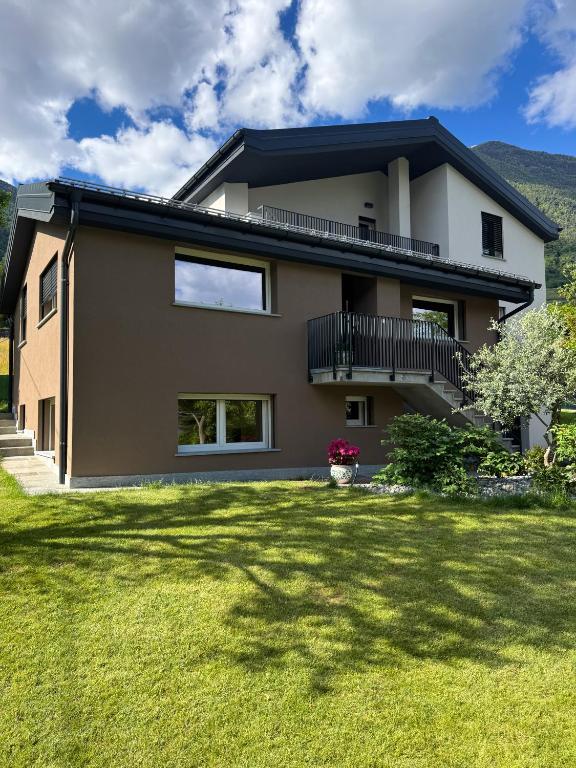 a house with a lawn in front of it at Enrichetta Apartment in Castione Andevenno