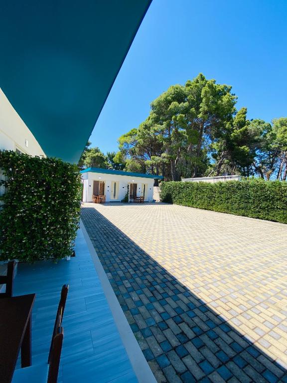 a view from the outside of a house with a brick patio at "Seaside Pines" Apartments in Vlorë