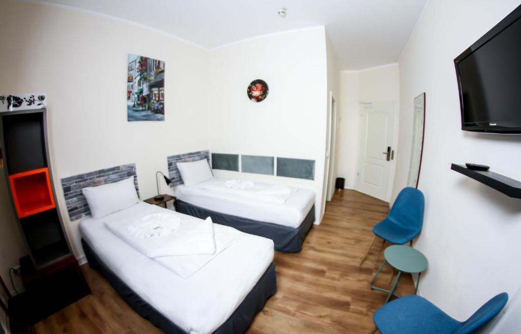 Postel nebo postele na pokoji v ubytování Hotel Karlshorst