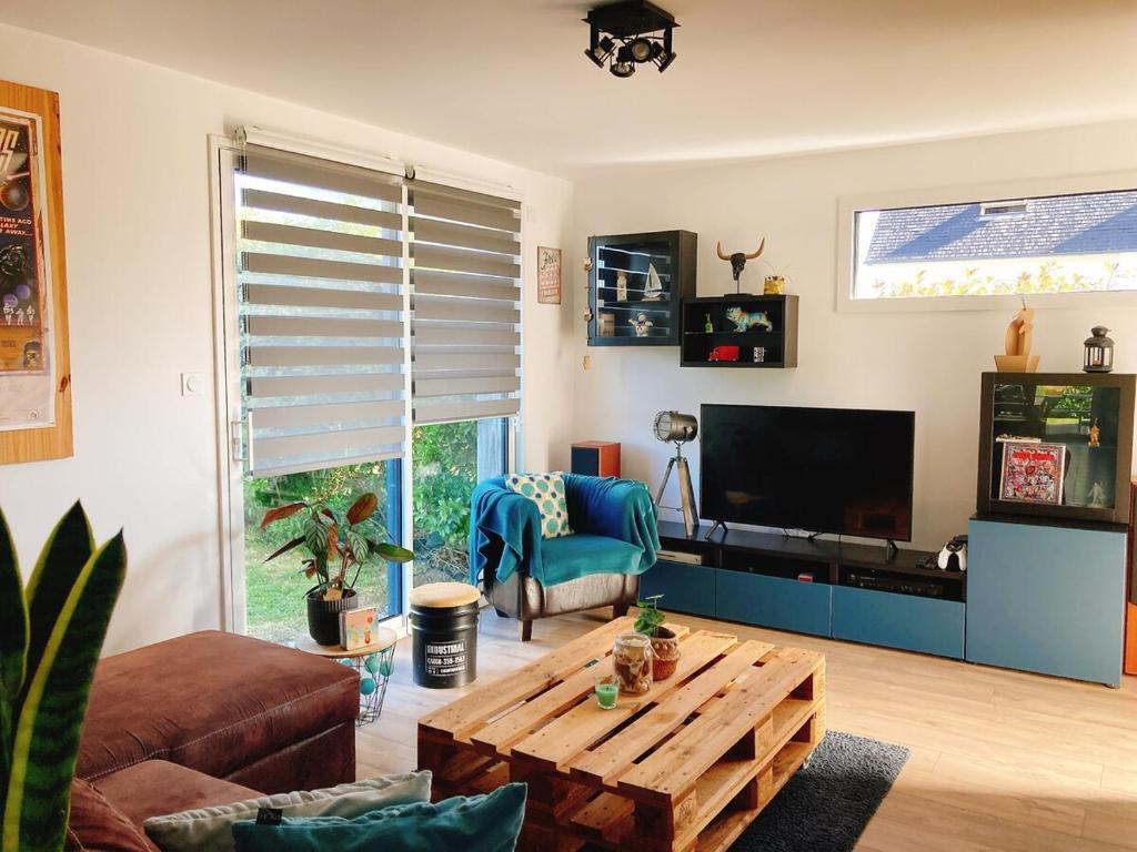 a living room with a coffee table and a television at KER NALA - Jolie maison familiale pour 5 vacanciers in Plouharnel