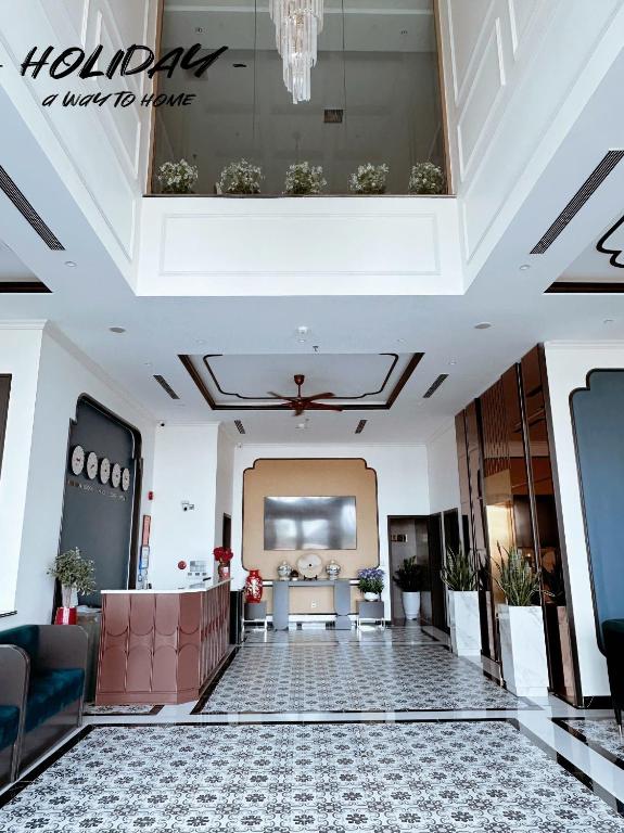 a lobby of a hotel with a large ceiling at Holiday Hotel Van Don in Tài Xá