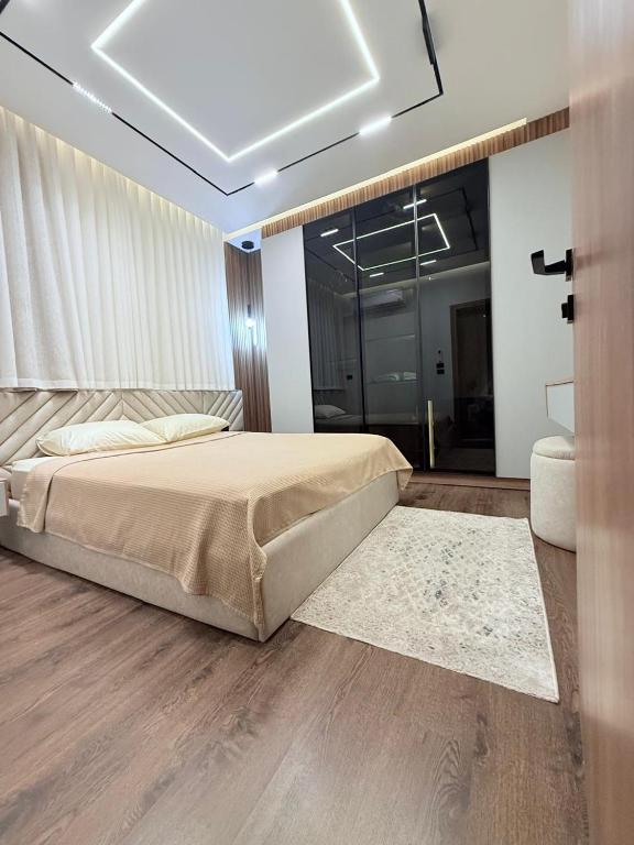 a bedroom with a large bed with a rug at madintay b8 modern cozy studio in Madinaty