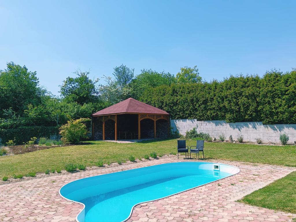a swimming pool in a yard with a gazebo at Welcome Home in Kutná Hora