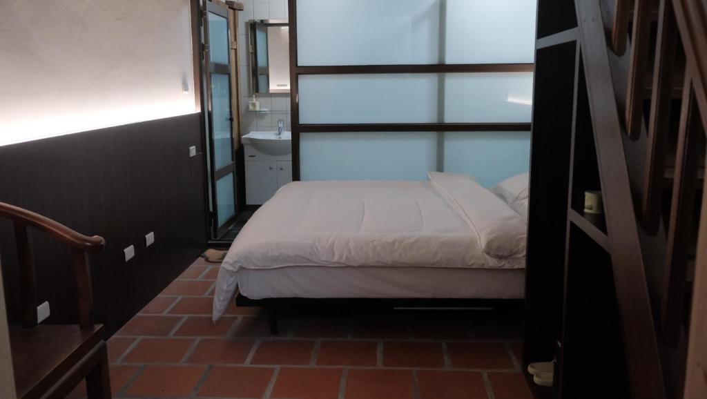 Ένα ή περισσότερα κρεβάτια σε δωμάτιο στο Wuhe Hotel
