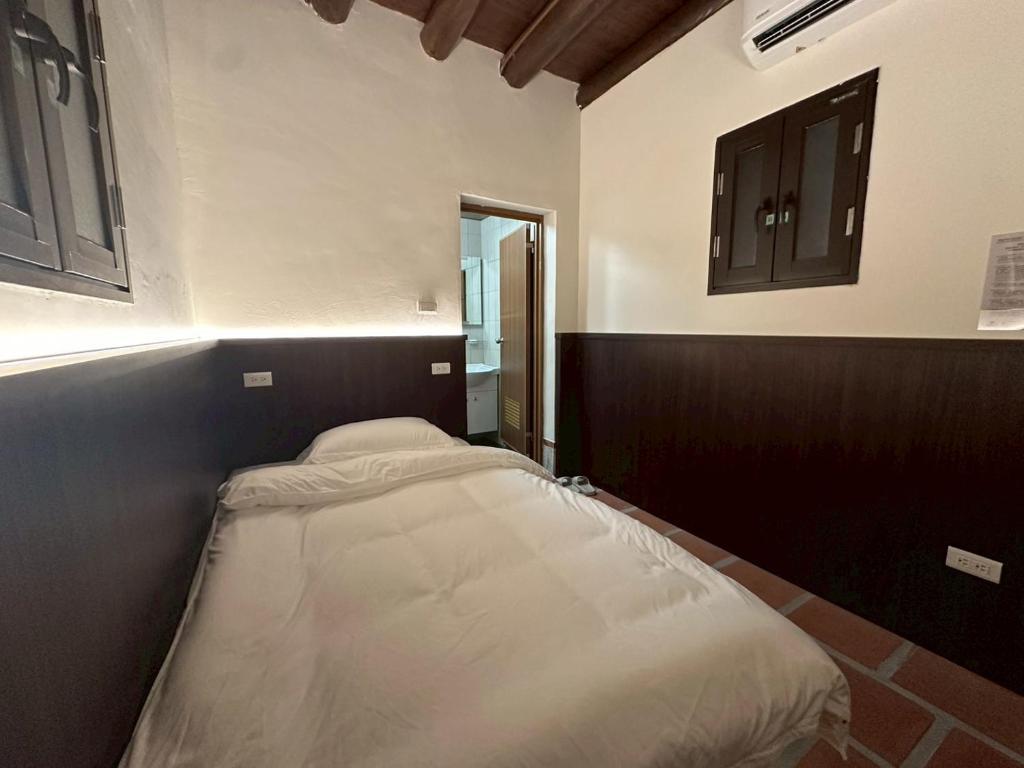 Ένα ή περισσότερα κρεβάτια σε δωμάτιο στο Wuhe Hotel