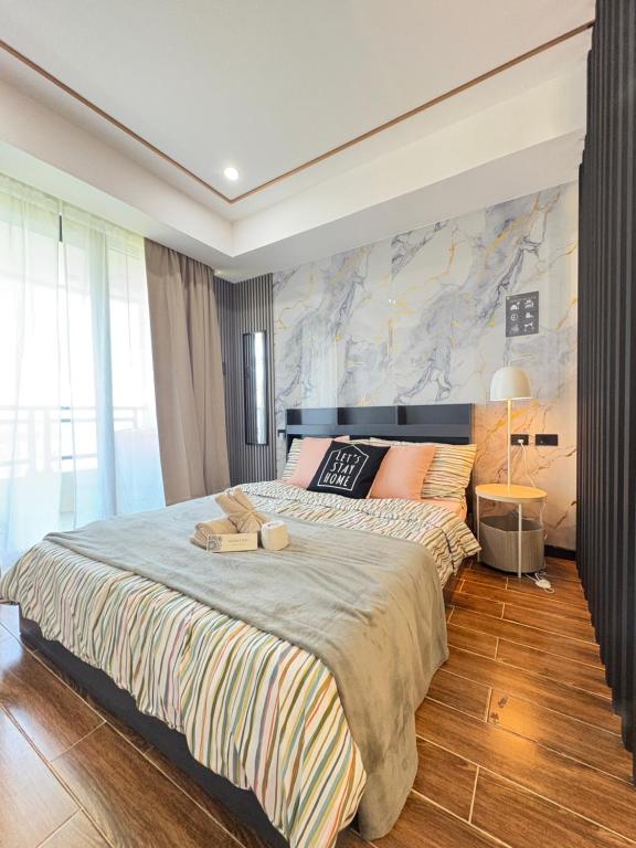 a bedroom with a large bed with a large wall at Sybaysuites staycation near Okada COD MOA NAIA airport Solaire in Manila