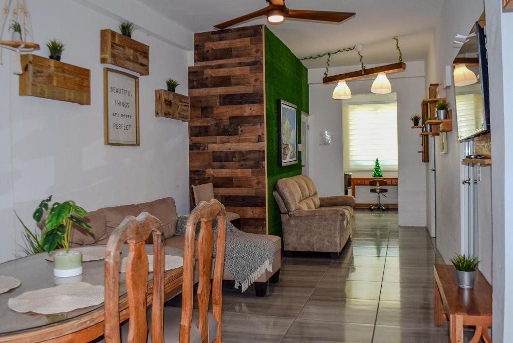 a living room with a table and a couch at VSS Rustic in Arecibo - Stylish & Relaxing Escape Near Beaches in Arecibo