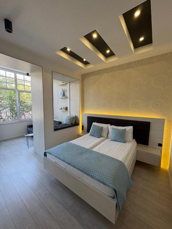 萨拉热窝Boulevard Apartments的带一张大床和一面镜子的卧室