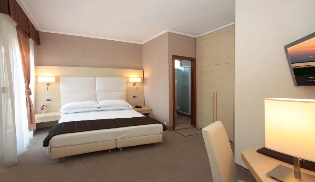 Postel nebo postele na pokoji v ubytování Hotel Rivamare