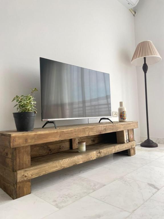 a television on a wooden table in a living room at Seven Sky appartment in Tunis in La Goulette