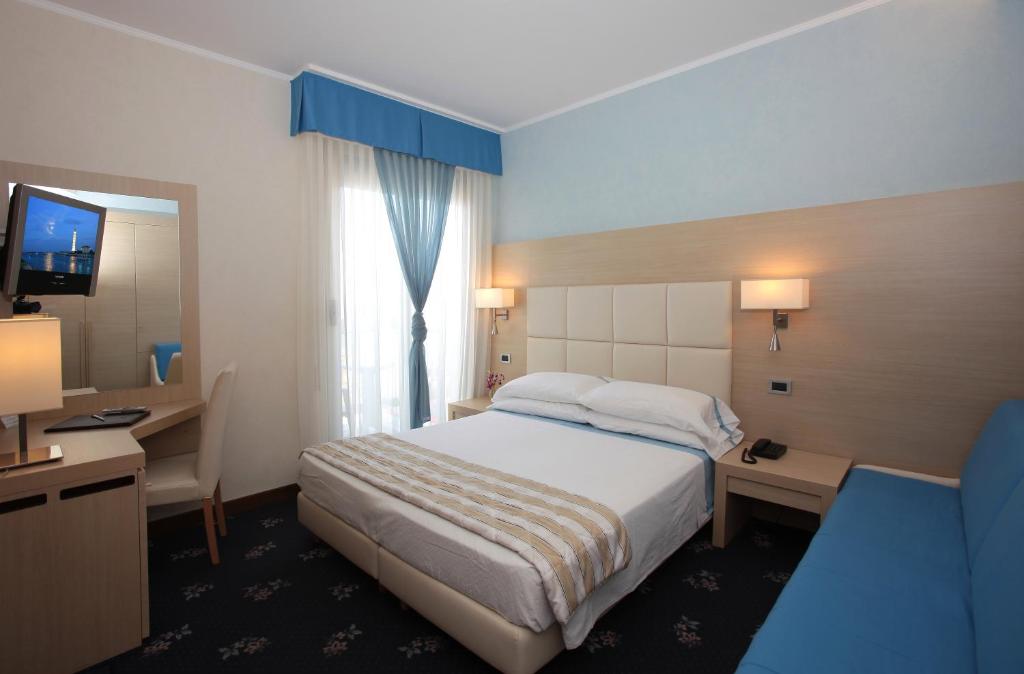 Postel nebo postele na pokoji v ubytování Hotel Rivamare