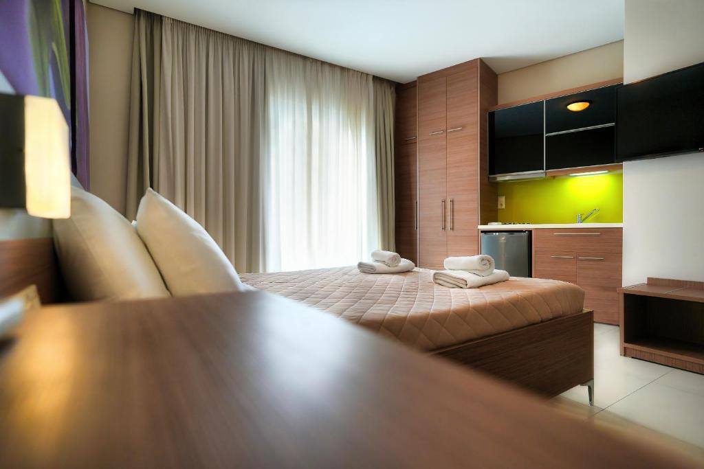 a hotel room with a bed with towels on it at Relax Hotel in Palaiochora