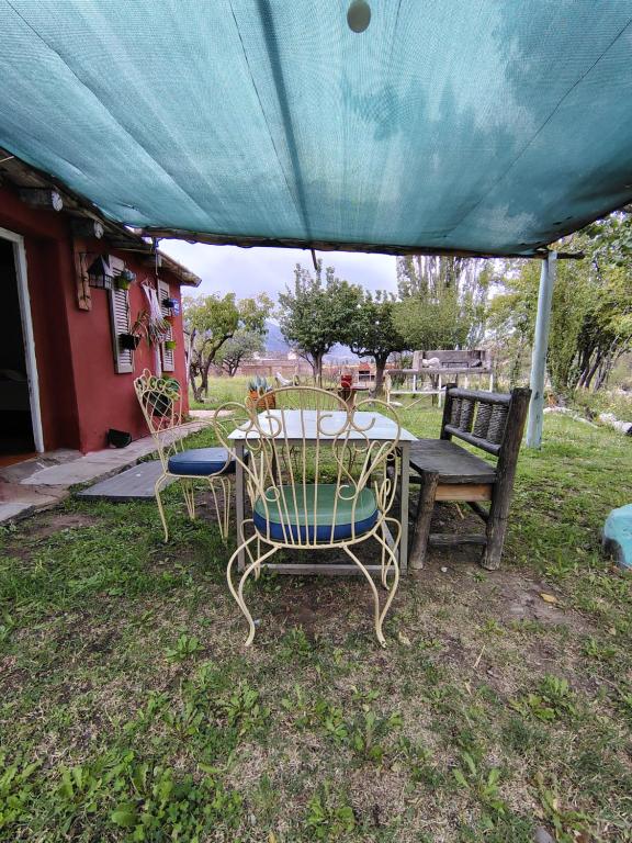 une table et des chaises assises sous une tente dans l'établissement Fox Den, à Luján de Cuyo