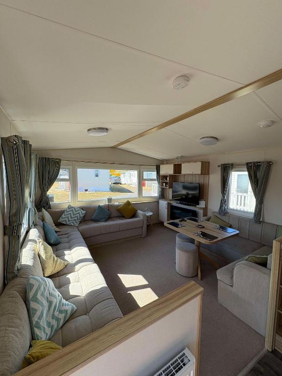 a living room with a couch and a table at Biggerstaffs retreat in Lossiemouth