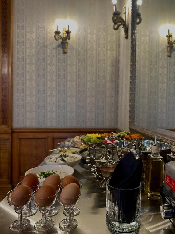 a long table with plates of food and wine glasses at The Benjamin House in Rīga