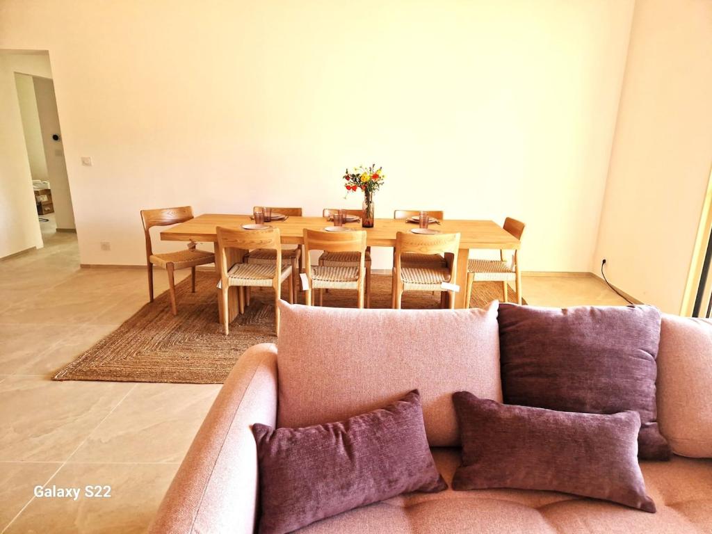 - un salon avec un canapé et une table à manger dans l'établissement Charming stone villa with pool, à Figari