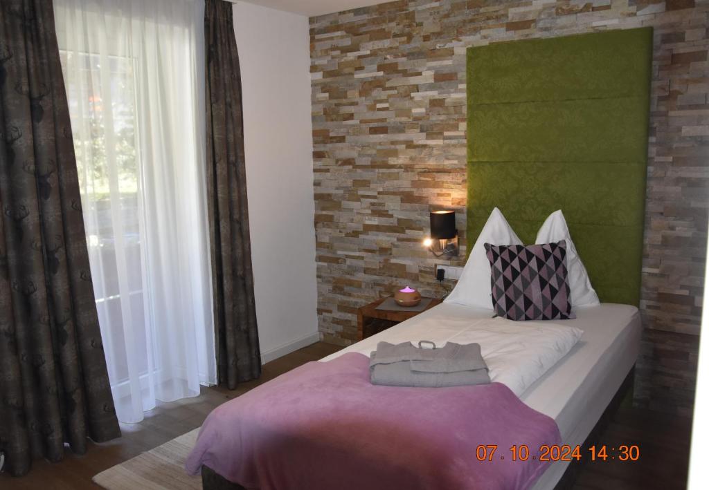 A bed or beds in a room at Landhotel Anna
