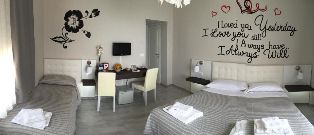 A bed or beds in a room at Athena Charming Rooms