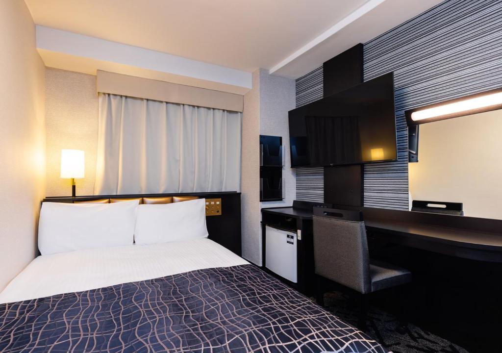 Postel nebo postele na pokoji v ubytování APA Hotel Niigata Higashinakadori